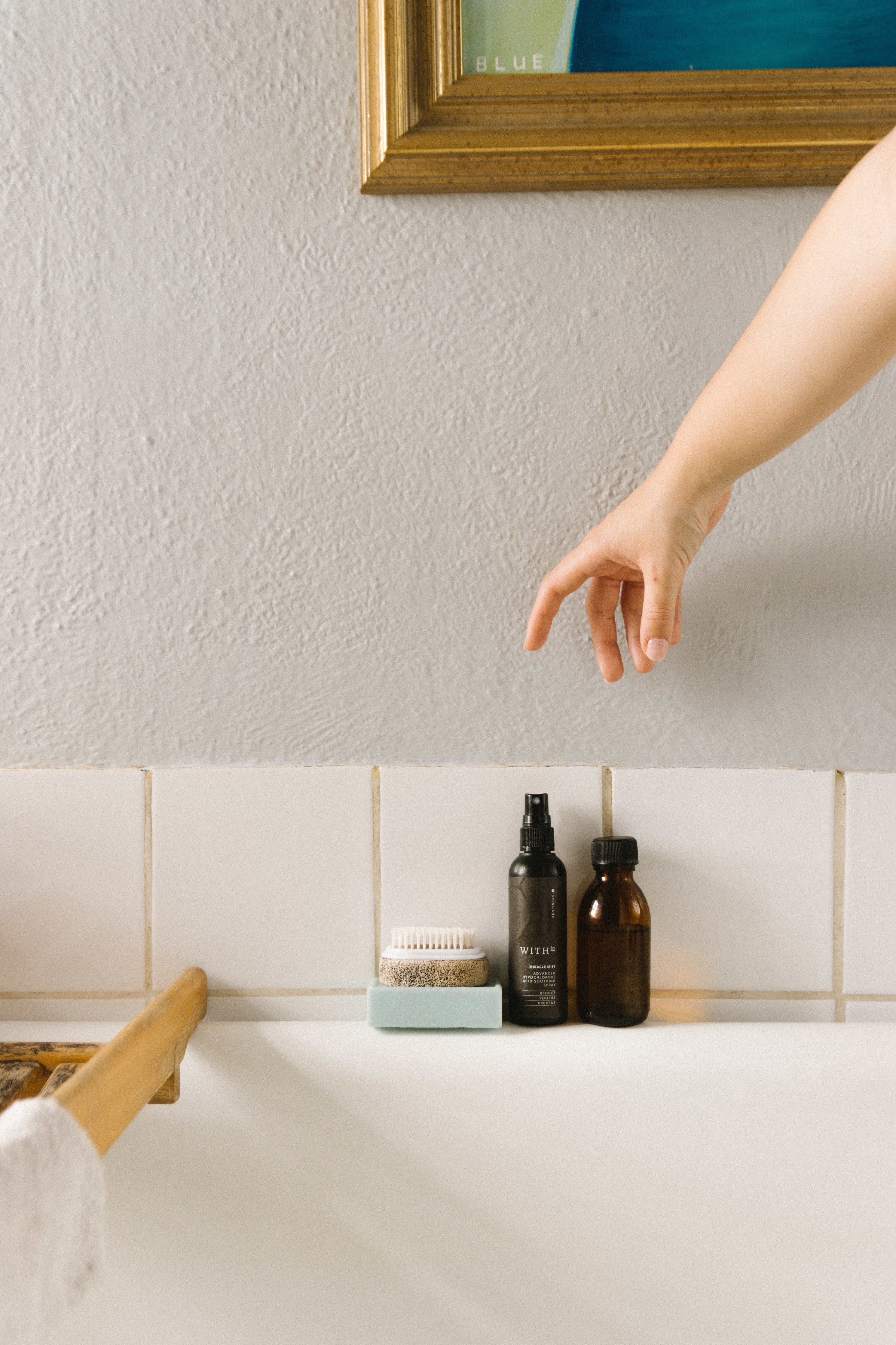 Within Skincare Hypochlorous Acid (HOCl), hand reaching for bottle